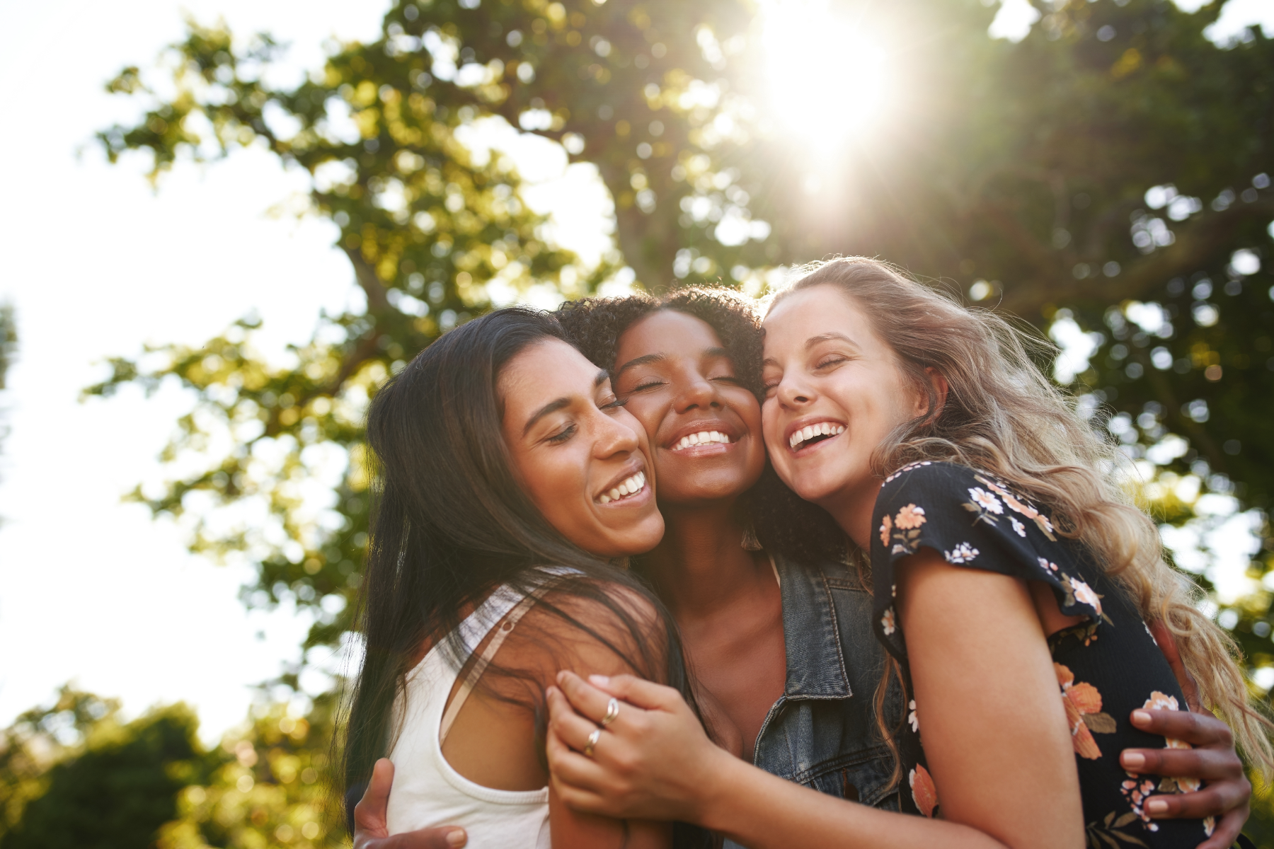 three-women-hugging-outside_313593749