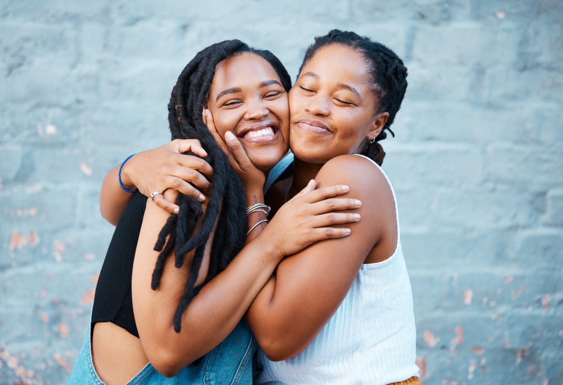 two-women-hugging-outside_536580357